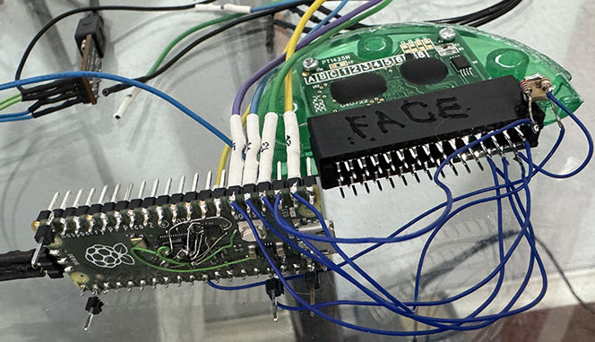 A messy images with a Pi Pico 2 connected to a connector holding a Pixter Color cartridge