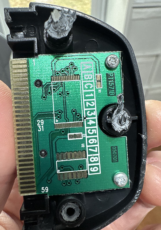 Broken open Pixter Multimedia cart with an unpopulated circuit board in it